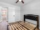 Bedroom with wood look floors featuring a black frame bed and bathroom entrance at 4401 S Trask St, Tampa, FL 33611