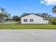 Exterior view of the house featuring a well-maintained yard and white privacy fence at 4401 S Trask St, Tampa, FL 33611