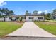Charming single-story home with a well-manicured lawn, black accents and a quaint front porch at 4401 S Trask St, Tampa, FL 33611