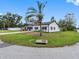 Charming single-story home with manicured lawn, mature landscaping, and palm tree at 4401 S Trask St, Tampa, FL 33611