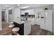 Modern kitchen featuring an island with seating, white cabinets, stainless steel appliances, and wood floors at 4401 S Trask St, Tampa, FL 33611