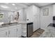Bright kitchen features granite counters, stainless steel fridge, white cabinets, and wood-look flooring at 4401 S Trask St, Tampa, FL 33611