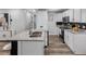 Modern kitchen featuring an island with sink, white cabinets, stainless steel appliances, and granite countertops at 4401 S Trask St, Tampa, FL 33611