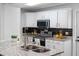 Bright and stylish kitchen with granite countertops, stainless steel appliances and black backsplash at 4401 S Trask St, Tampa, FL 33611
