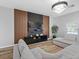 Modern living room with wood floors, a media center, a decorative wall, and comfortable sectional seating at 4401 S Trask St, Tampa, FL 33611