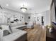 Bright living room features a decorative chandelier and an open-concept to the kitchen and dining areas at 4401 S Trask St, Tampa, FL 33611