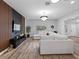 Bright living room with modern entertainment center and a comfortable sectional sofa and new flooring at 4401 S Trask St, Tampa, FL 33611