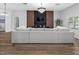 Spacious living room with large sofa, modern lighting, and decorative wood-look paneling on the wall at 4401 S Trask St, Tampa, FL 33611