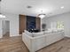 Bright living room features an entertainment center, elegant chandelier and comfortable sectional seating at 4401 S Trask St, Tampa, FL 33611