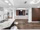 Open-concept living space featuring a kitchen with breakfast bar, and view into living room with sofa at 4401 S Trask St, Tampa, FL 33611