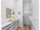 Bright walk-in closet with white shelves and ample storage for your entire wardrobe collection at 4401 S Trask St, Tampa, FL 33611