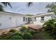 Charming patio area with brick pavers, mature landscaping, and outdoor access at 4711 12Th N St, St Petersburg, FL 33703