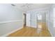 Inviting bedroom with hardwood floors, closet with sliding mirror doors, and bright white trim at 4711 12Th N St, St Petersburg, FL 33703