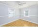 Cozy bedroom with hardwood floors, crown molding, and natural light from two windows at 4711 12Th N St, St Petersburg, FL 33703