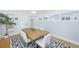 Dining room with wooden table, white chairs, hardwood floors, and neutral paint at 4711 12Th N St, St Petersburg, FL 33703