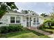 Charming home featuring a brick path leading to the front door and lush landscaping at 4711 12Th N St, St Petersburg, FL 33703