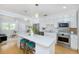 Open kitchen featuring white cabinets, quartz countertop island, and stainless steel appliances at 4711 12Th N St, St Petersburg, FL 33703