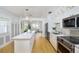 Bright, open kitchen featuring white cabinets, quartz countertop island and stainless steel appliances at 4711 12Th N St, St Petersburg, FL 33703