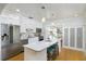 Modern kitchen with white cabinets, stainless steel appliances, and an island with seating at 4711 12Th N St, St Petersburg, FL 33703