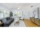 Bright living room with hardwood floors, a modern rug and a comfortable grey couch at 4711 12Th N St, St Petersburg, FL 33703
