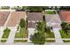 Aerial view of home showing roof, lawn, and proximity to nearby neighborhood at 4735 Red Pine Way, Wesley Chapel, FL 33545