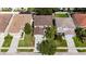 Aerial view of neighborhood showcasing roof, driveway and mature landscaping at 4735 Red Pine Way, Wesley Chapel, FL 33545