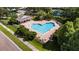 Aerial view of a community pool featuring lounge chairs and a unique heart shape at 4735 Red Pine Way, Wesley Chapel, FL 33545