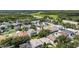 An aerial view highlights a backyard oasis, featuring lush greenery and a sparkling pool with a screened-in lanai at 4735 Red Pine Way, Wesley Chapel, FL 33545