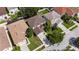 An aerial view shows a well maintained home with a manicured lawn and a long driveway leading to an attached garage at 4735 Red Pine Way, Wesley Chapel, FL 33545