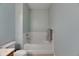 Clean bathroom showcasing a bathtub with tiled walls and modern fixtures at 4735 Red Pine Way, Wesley Chapel, FL 33545