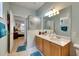 Bright bathroom featuring a glass-enclosed shower, double sinks, and stylish mirror at 4735 Red Pine Way, Wesley Chapel, FL 33545