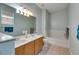 Bathroom featuring double sink vanity with light fixtures above a tub shower combo at 4735 Red Pine Way, Wesley Chapel, FL 33545