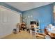 Bedroom features a closet, blue accent wall, and carpeted floors at 4735 Red Pine Way, Wesley Chapel, FL 33545