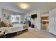 Bedroom showcasing a queen bed, dresser, TV, and access to the kitchen at 4735 Red Pine Way, Wesley Chapel, FL 33545