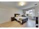 Bright bedroom features a queen bed, nightstand, and natural light from the window at 4735 Red Pine Way, Wesley Chapel, FL 33545