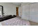 Bedroom with neutral walls, carpeted floor, and a mirrored dresser at 4735 Red Pine Way, Wesley Chapel, FL 33545