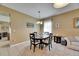 Cozy dining area featuring a round table, chandelier and natural light at 4735 Red Pine Way, Wesley Chapel, FL 33545