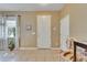Welcoming entryway with a white door, tile floors, and ample lighting at 4735 Red Pine Way, Wesley Chapel, FL 33545