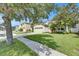 Charming home in a peaceful neighborhood with lush green lawn and tree-lined street at 4735 Red Pine Way, Wesley Chapel, FL 33545