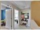 Upstairs hallway with view into bedroom, showcasing decor and a comfortable, stylish interior at 4735 Red Pine Way, Wesley Chapel, FL 33545