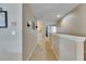 Bright hallway with carpet and neutral walls, offering seamless transition between rooms at 4735 Red Pine Way, Wesley Chapel, FL 33545