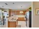 Well-lit kitchen with stainless steel appliances, light countertops, and warm wooden cabinetry for a welcoming feel at 4735 Red Pine Way, Wesley Chapel, FL 33545