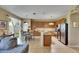 Open floor plan showing kitchen, dining area, and living area with natural light at 4735 Red Pine Way, Wesley Chapel, FL 33545