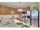 Modern kitchen with stainless appliances, spacious countertops, and warm cabinetry, perfect for cooking and entertaining at 4735 Red Pine Way, Wesley Chapel, FL 33545