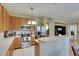 Open kitchen with breakfast bar, stainless appliances, and tile flooring at 4735 Red Pine Way, Wesley Chapel, FL 33545