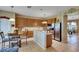 Charming eat-in kitchen features wooden cabinetry, stainless steel appliances, and a breakfast bar at 4735 Red Pine Way, Wesley Chapel, FL 33545