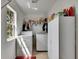 Functional laundry room equipped with washer, dryer, storage cabinets, and a bright window for ventilation at 4735 Red Pine Way, Wesley Chapel, FL 33545