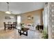 Open concept floor plan with living and dining area with neutral decor at 4735 Red Pine Way, Wesley Chapel, FL 33545
