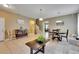 Open-concept living room featuring tile floors, neutral walls and natural light at 4735 Red Pine Way, Wesley Chapel, FL 33545