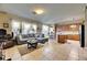Open-concept living room with tiled floors flowing into the eat-in kitchen at 4735 Red Pine Way, Wesley Chapel, FL 33545